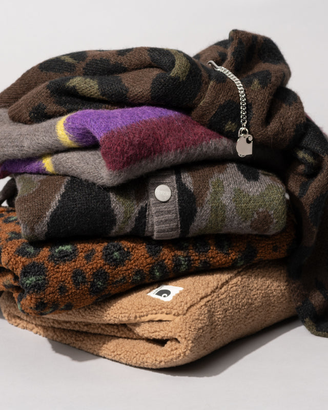 A stack of sweaters for Carhartt WIP Gift Guide